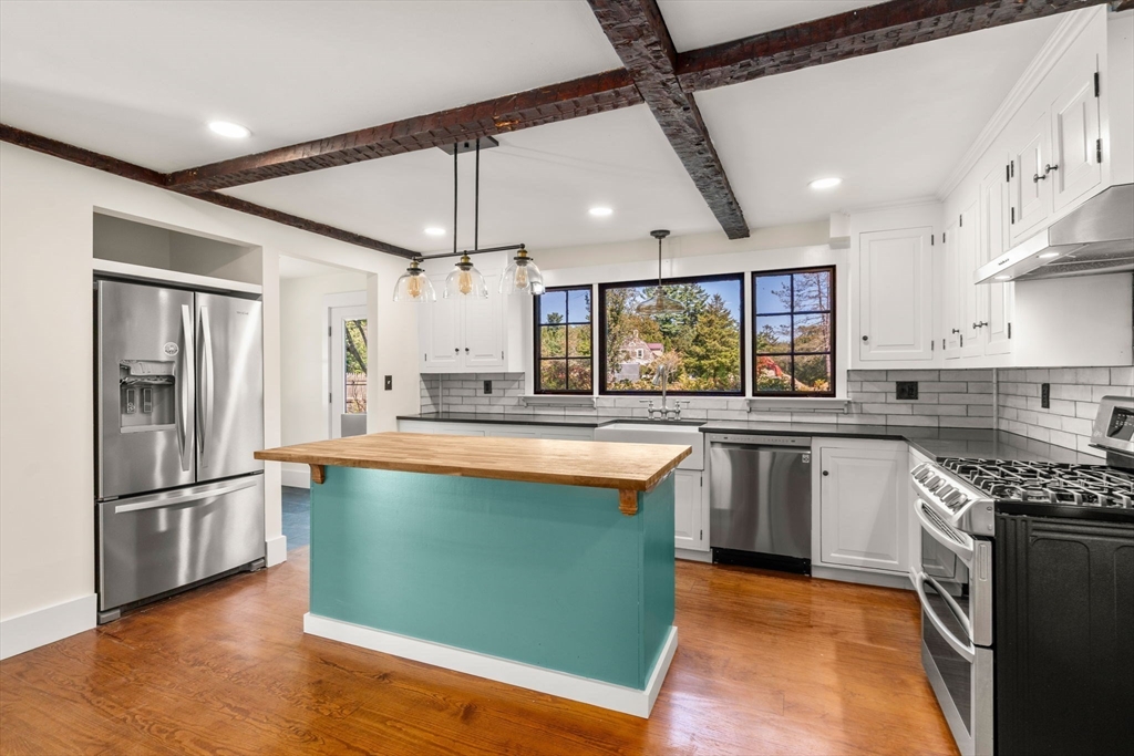 1011 Edmands Road Framingham, MA 01701 - Photo 7 of 36 a kitchen with stainless steel appliances granite countertop a refrigerator a sink dishwasher a stove and white cabinets with wooden floor