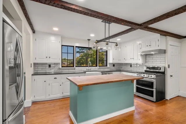 a kitchen with stainless steel appliances granite countertop a sink and stove