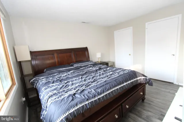 a bed sitting in a bedroom next to a window