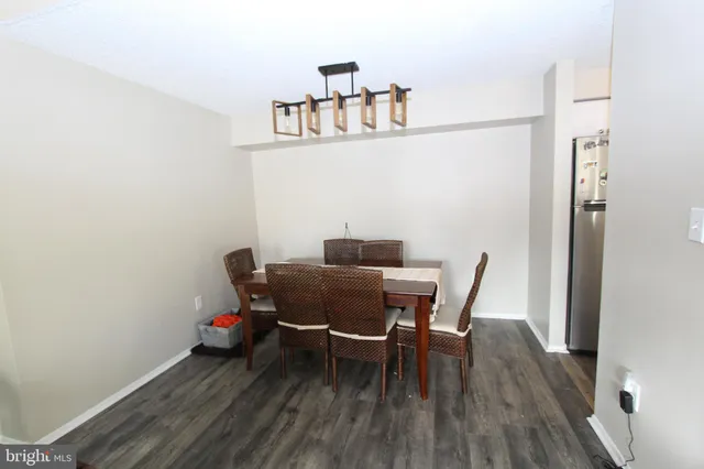 a dining room with furniture and wooden floor