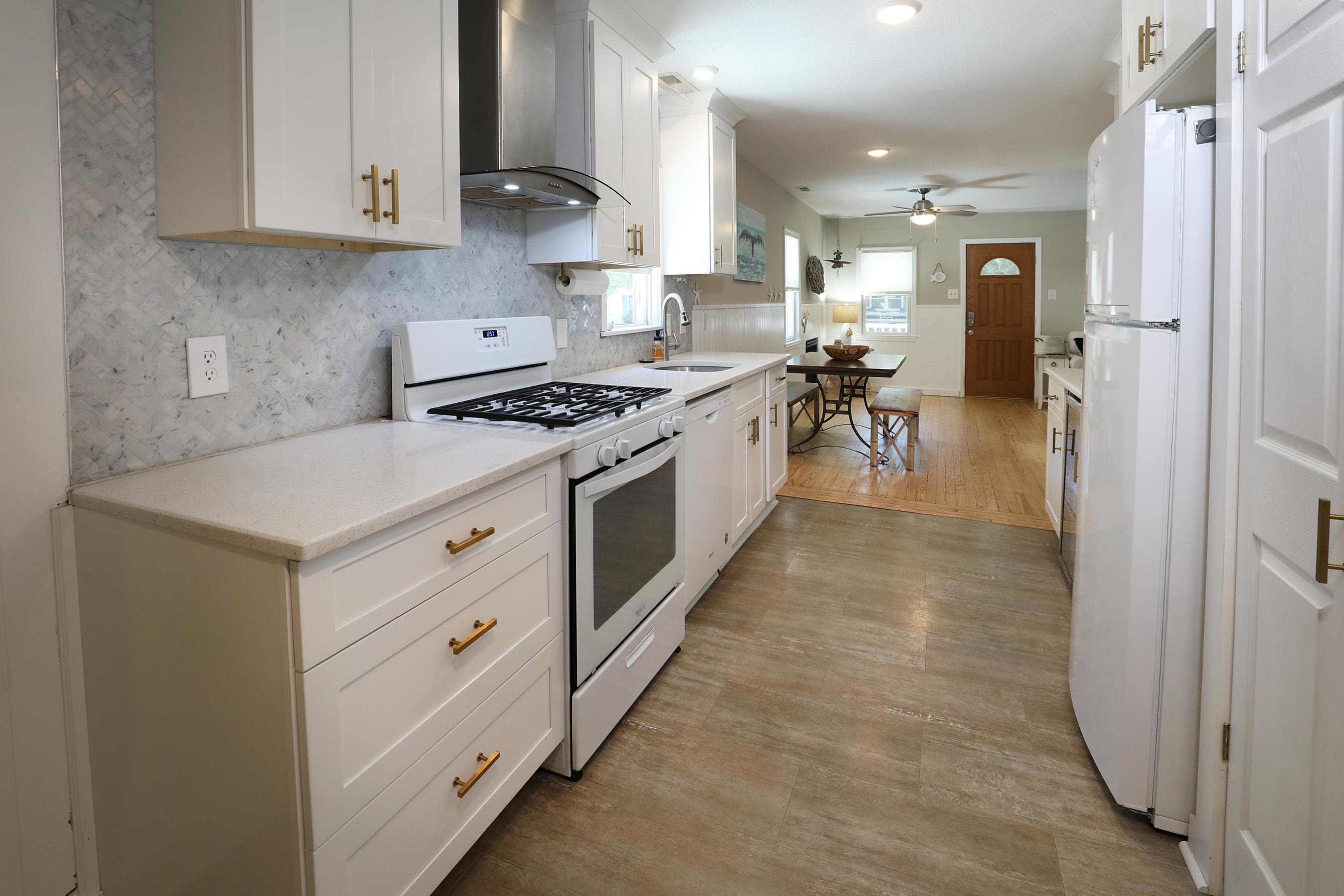 21 Beverly Road Cape May, NJ 08204 - Photo 17 of 38 a kitchen with white cabinets and appliances