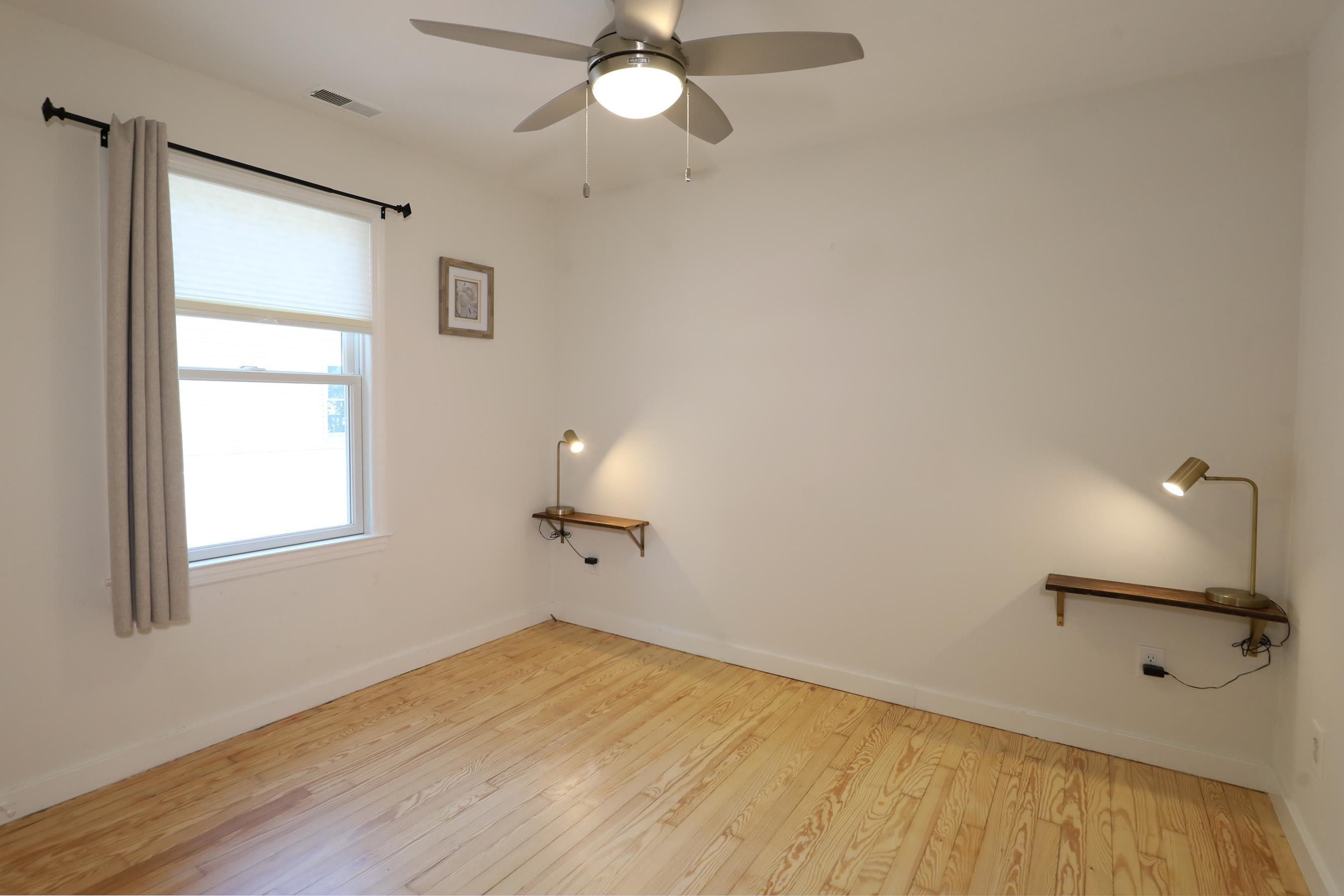 21 Beverly Road Cape May, NJ 08204 - Photo 31 of 38 wooden floor in an empty room with a window