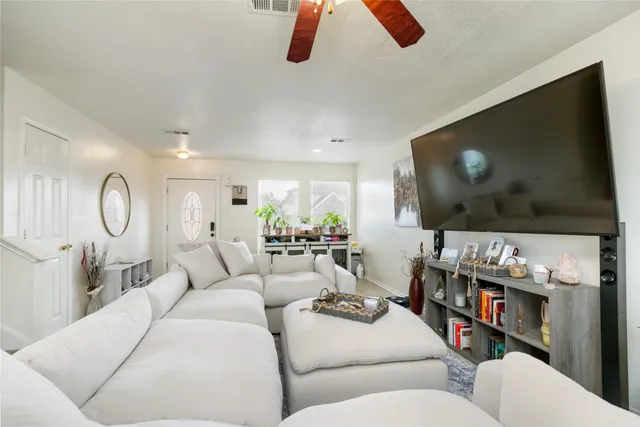 a living room with furniture and a flat screen tv