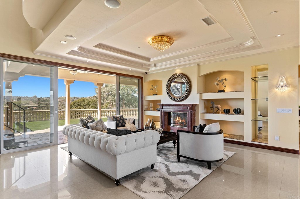 20895 Viento Valle Escondido, CA 92025 - Photo 11 of 75 a living room with furniture a clock and a large window with garden view