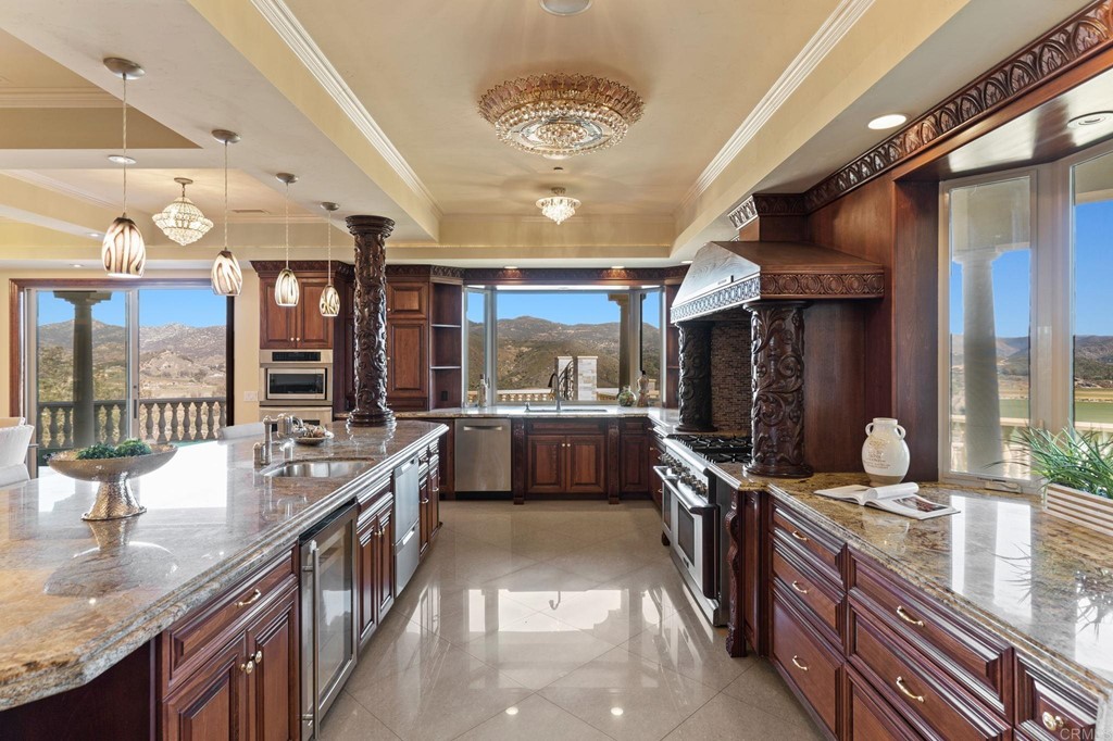 20895 Viento Valle Escondido, CA 92025 - Photo 22 of 75 a large kitchen with stainless steel appliances a large counter top a stove and a sink