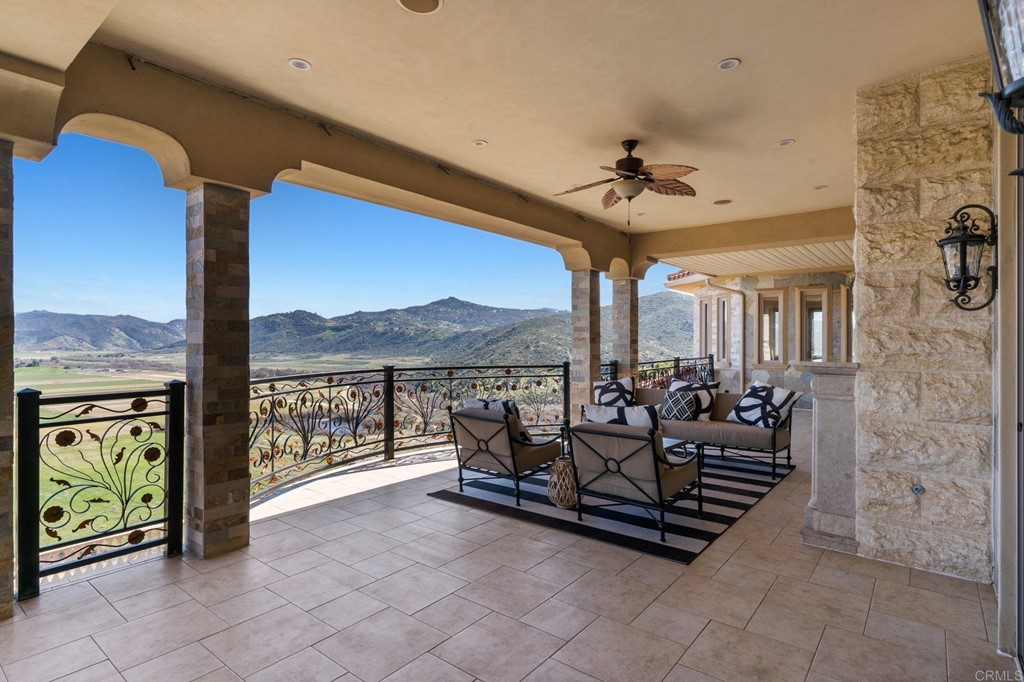 20895 Viento Valle Escondido, CA 92025 - Photo 32 of 75 a living room with patio furniture and a floor to ceiling window