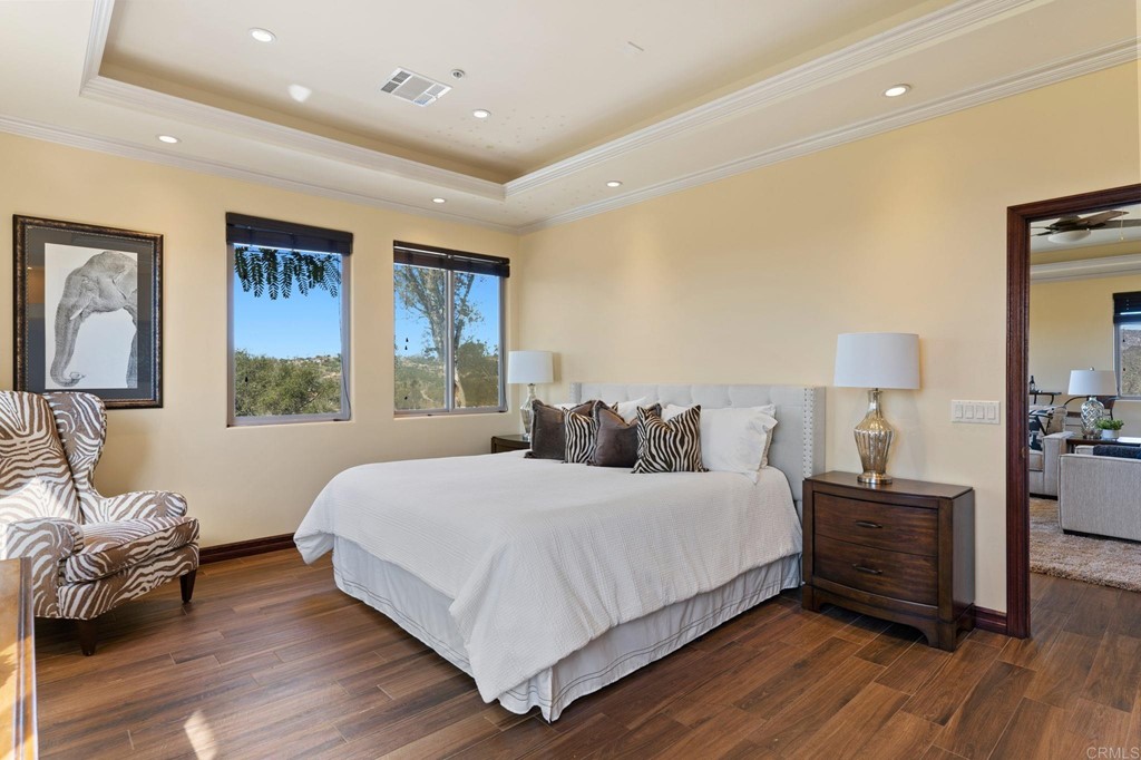 20895 Viento Valle Escondido, CA 92025 - Photo 59 of 75 a bedroom with a bed and wooden floor