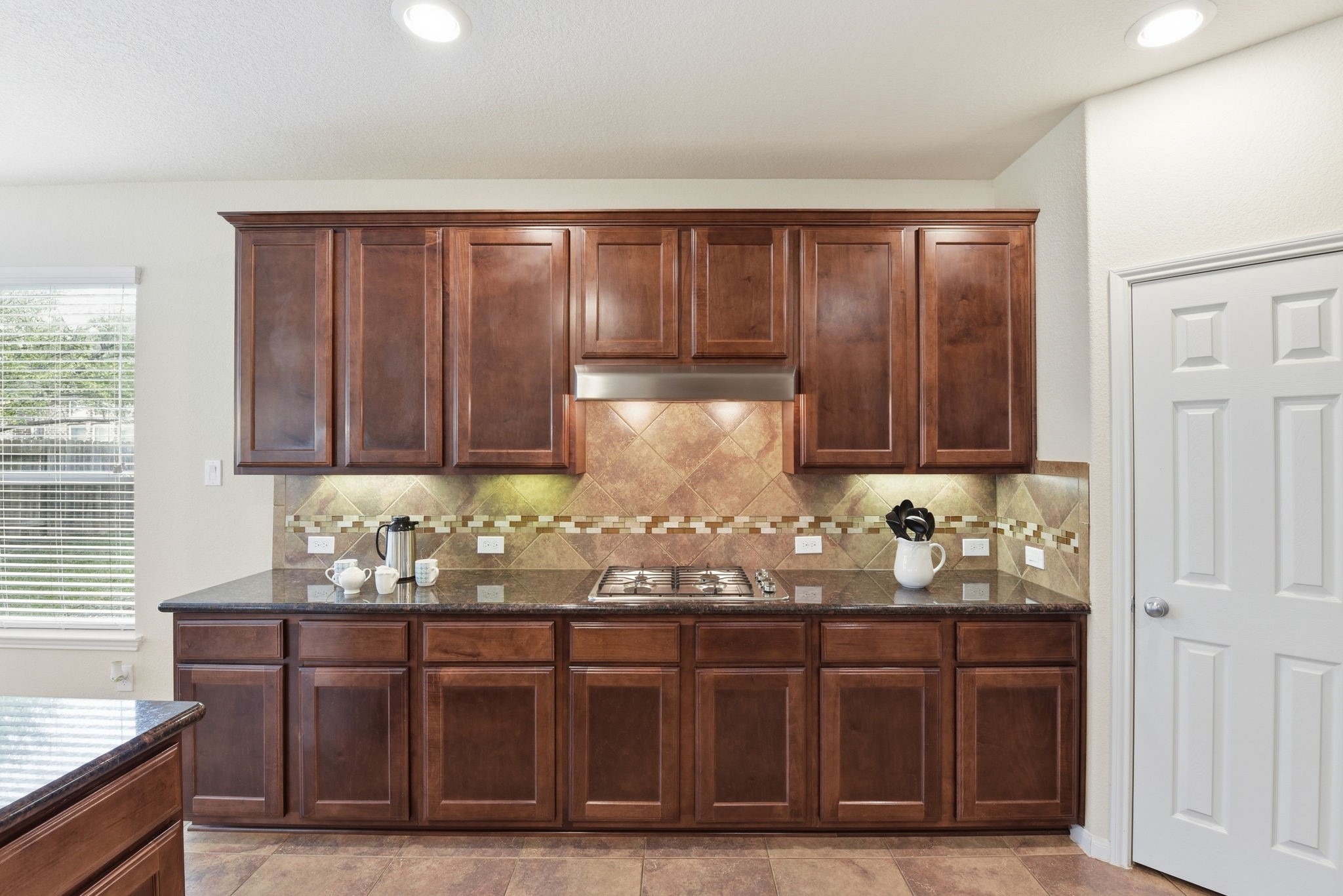 3301 Remington Rise Lane Katy, TX 77494 - Photo 12 of 50 a kitchen with granite countertop wooden cabinets and sink