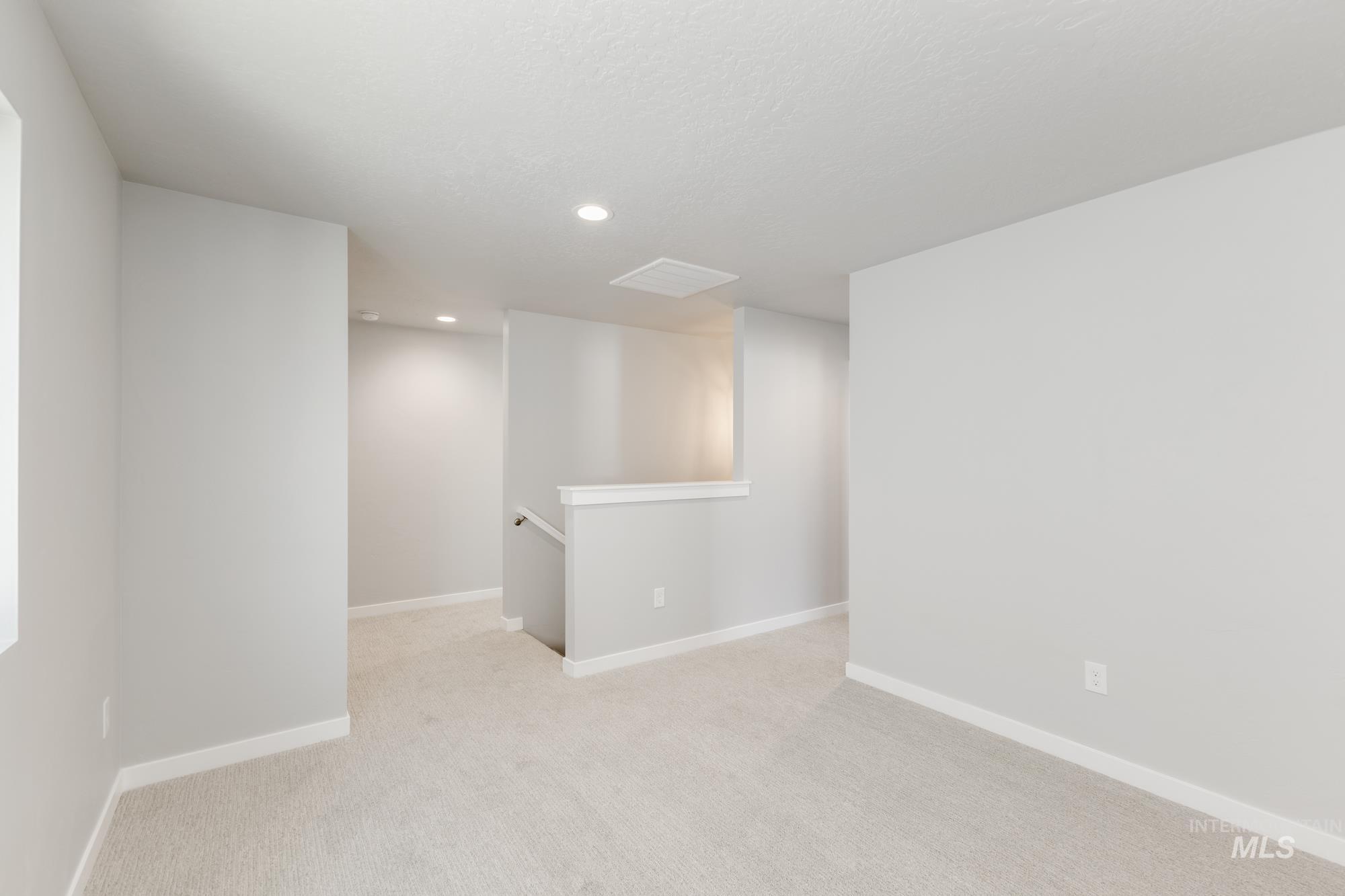 4166 East Kalinga Street Meridian, ID 83642 - Photo 12 of 22 Empty room with light colored carpet and recessed lighting