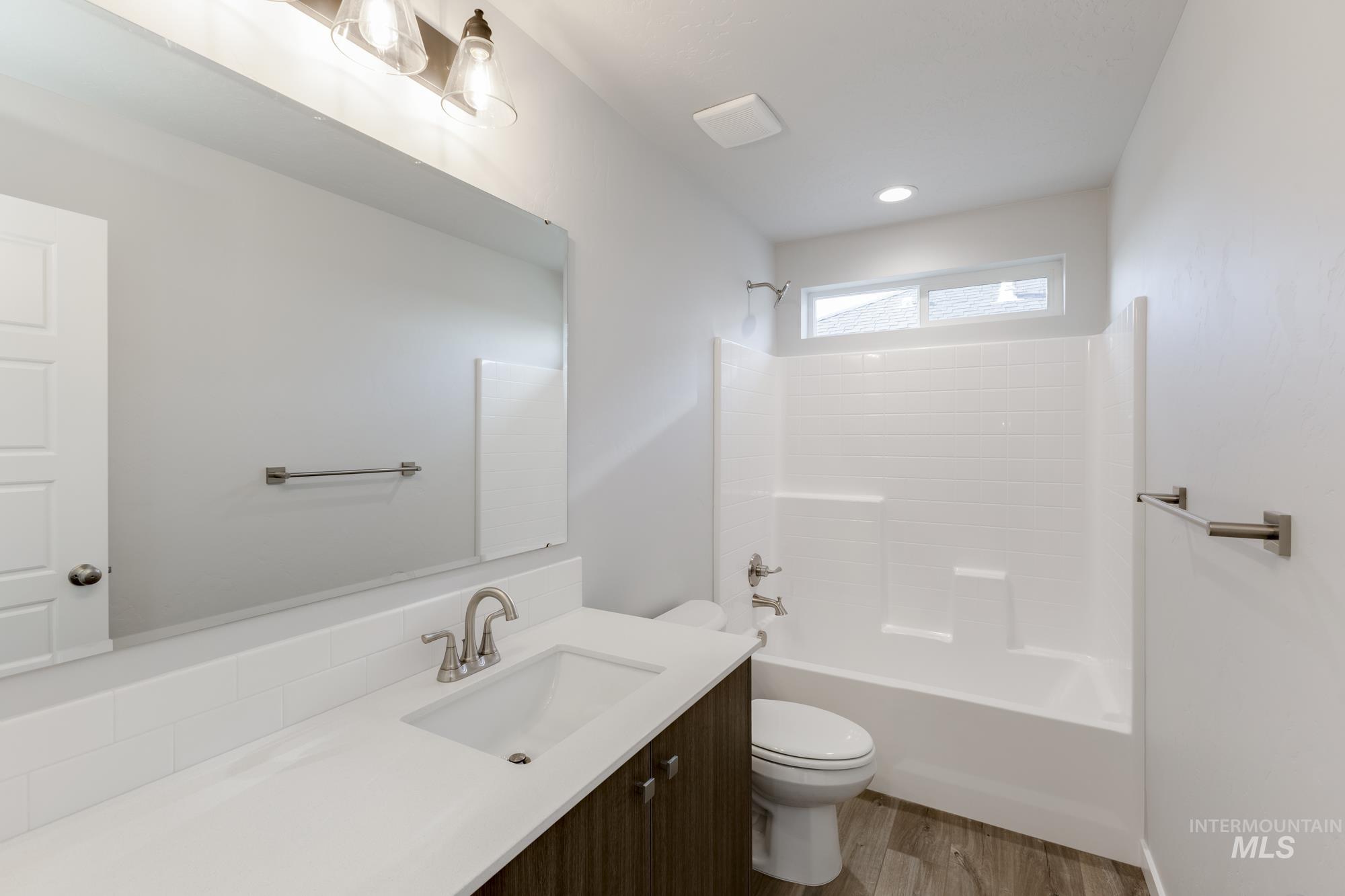 4166 East Kalinga Street Meridian, ID 83642 - Photo 15 of 22 Full bathroom with vanity, shower / bathtub combination, and dark wood-style floors