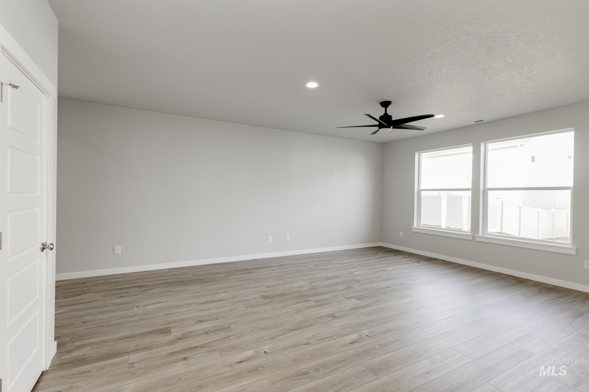 4166 East Kalinga Street Meridian, ID 83642 - Photo 8 of 22 Spare room with recessed lighting, light wood finished floors, and a ceiling fan