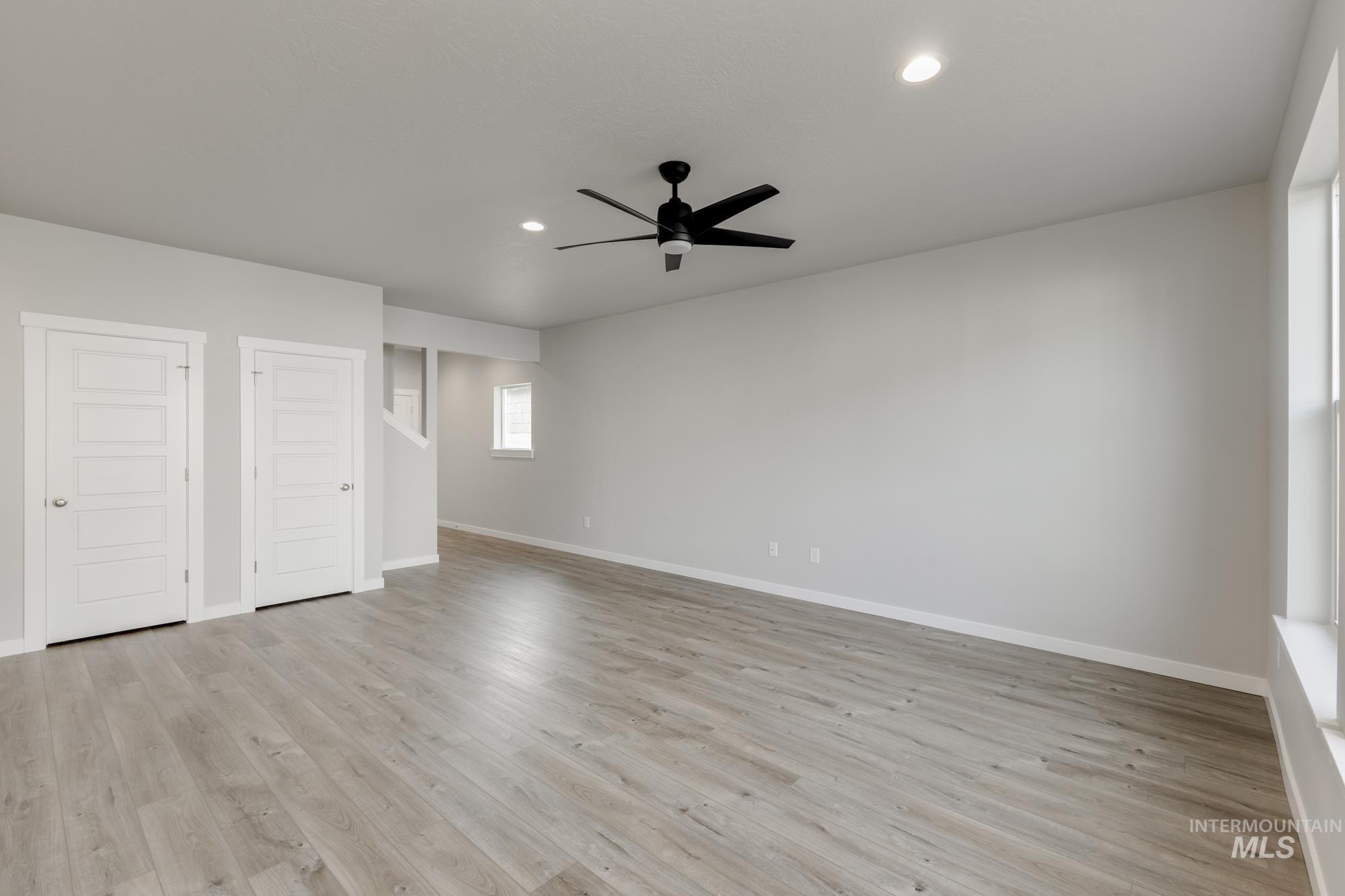 4166 East Kalinga Street Meridian, ID 83642 - Photo 9 of 22 Unfurnished bedroom featuring multiple closets, light wood-style flooring, recessed lighting, and ceiling fan