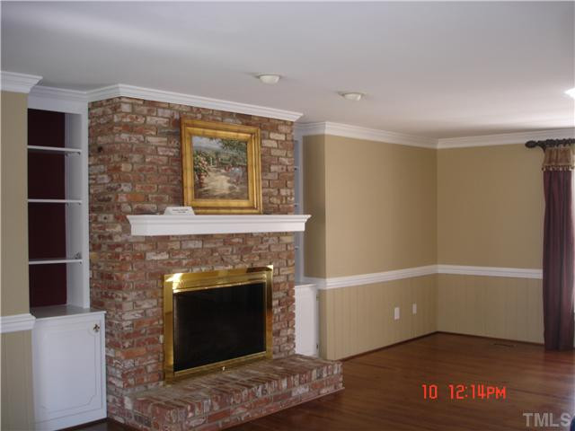 325 Sandhurst Road Raleigh, NC 27615 - Photo 8 of 12 This brick fireplace is centered in this room for optimum family enjoyment. The Gas logs are operated by the remove control. Heart of Pine Floors offer charm! Den/Family/Great Room