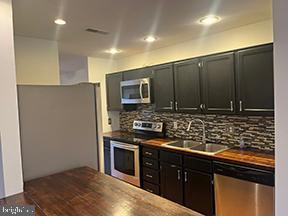 12 Pine Woods Court Reading, PA 19607 - Photo 3 of 10 a kitchen with stainless steel appliances granite countertop a stove a sink and a microwave