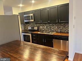 12 Pine Woods Court Reading, PA 19607 - Photo 4 of 10 a kitchen with stainless steel appliances granite countertop a stove and a microwave