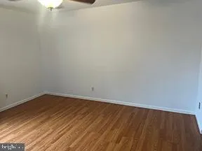 a view of a room with wooden floor