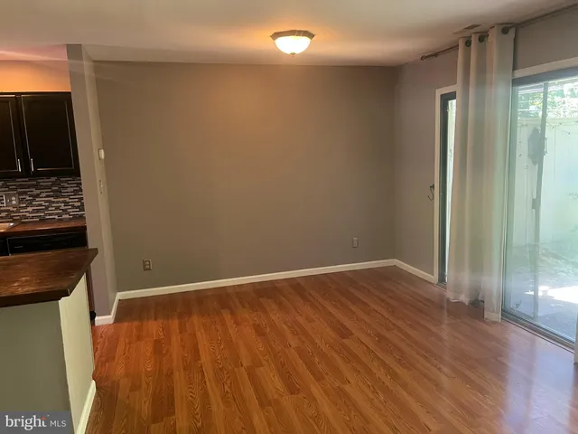 a view of a room with wooden floor and a sink
