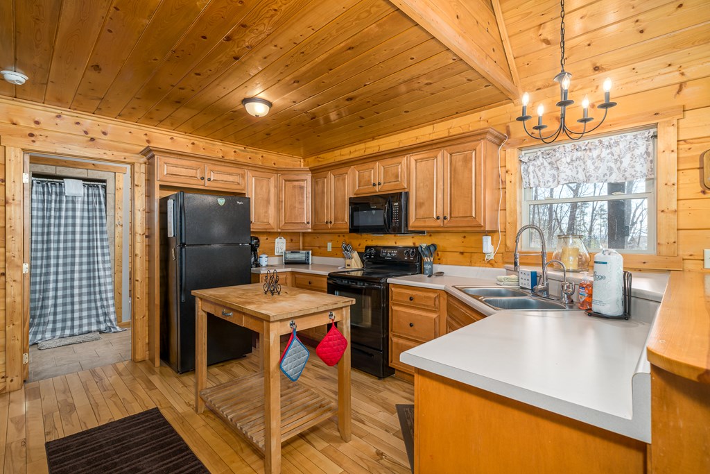 1529 Faith Court Ranger, GA 30734 - Photo 23 of 50 a kitchen that has a lot of cabinets a sink and a refrigerator