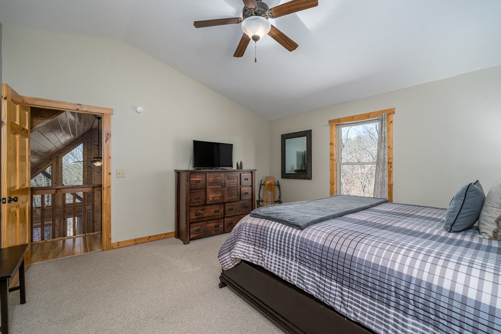 1529 Faith Court Ranger, GA 30734 - Photo 31 of 50 a bedroom with a bed and dresser with mirror