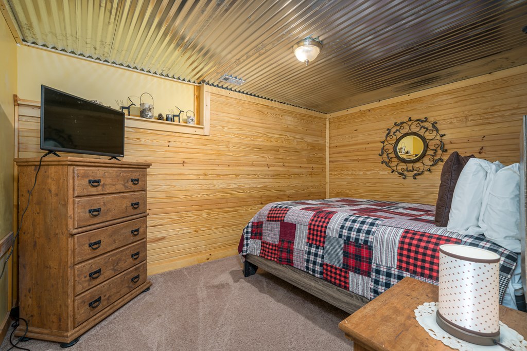 1529 Faith Court Ranger, GA 30734 - Photo 38 of 50 a bedroom with a bed and a flat screen tv