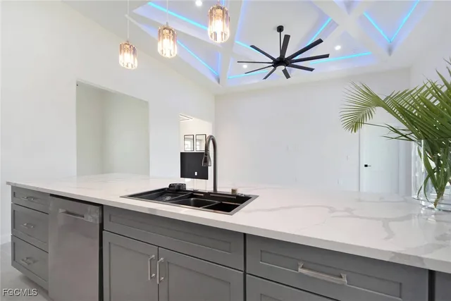 a kitchen with stainless steel appliances a refrigerator a microwave and sink