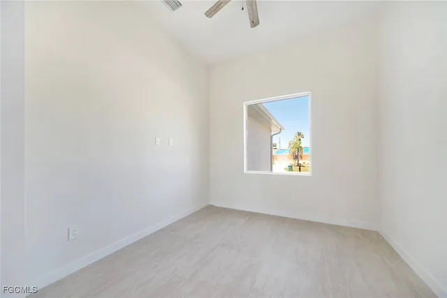 an empty room and a bathroom