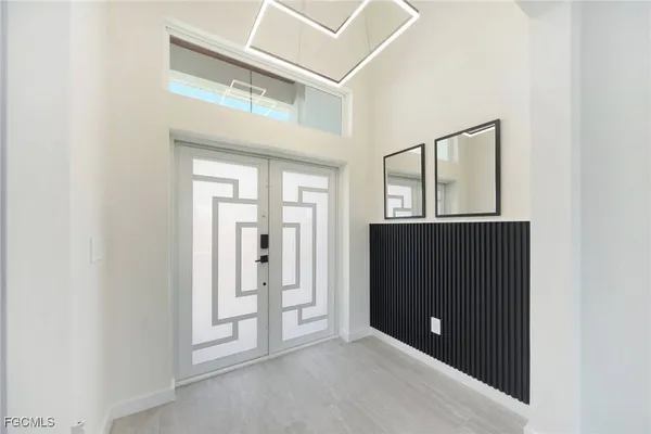 a living room with stainless steel appliances kitchen island furniture and a window