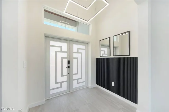 a living room with stainless steel appliances kitchen island furniture and a window