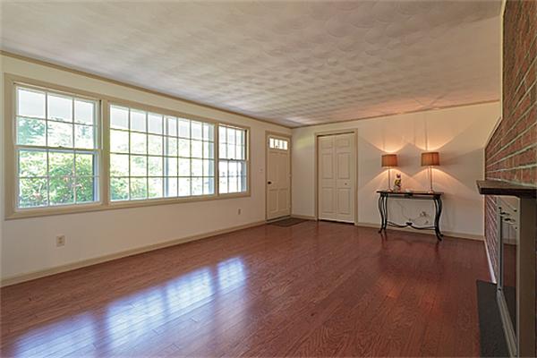 11 Irene Road Framingham, MA 01701 - Photo 3 of 16 a view of an empty room with wooden floor and a window