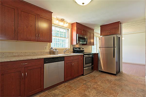 11 Irene Road Framingham, MA 01701 - Photo 4 of 16 a kitchen with stainless steel appliances granite countertop a refrigerator stove and sink