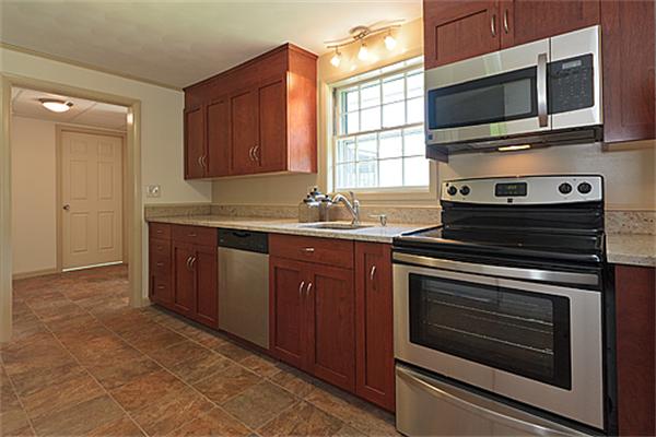 11 Irene Road Framingham, MA 01701 - Photo 5 of 16 a kitchen with stainless steel appliances a stove microwave and cabinets