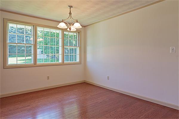 11 Irene Road Framingham, MA 01701 - Photo 6 of 16 an empty room with wooden floor and windows