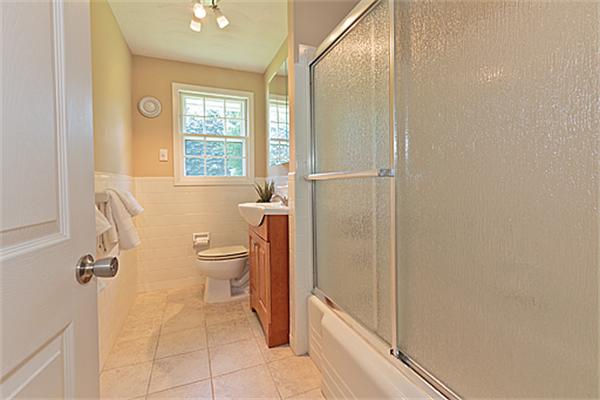 11 Irene Road Framingham, MA 01701 - Photo 9 of 16 a bathroom with a granite countertop toilet a sink and a mirror