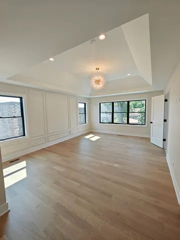 an empty room with windows and entrance