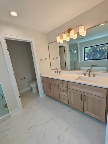 a spacious bathroom with a double vanity sink and a mirror