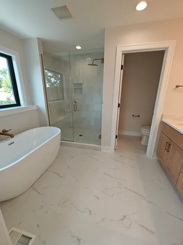 a bathroom with a tub shower and sink