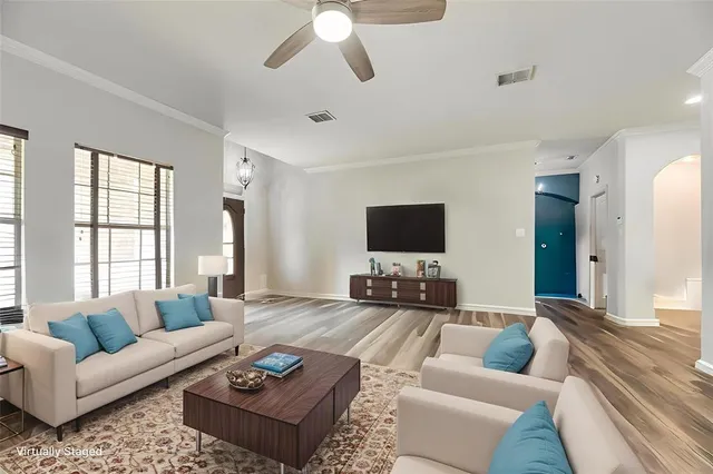 a living room with furniture and a flat screen tv