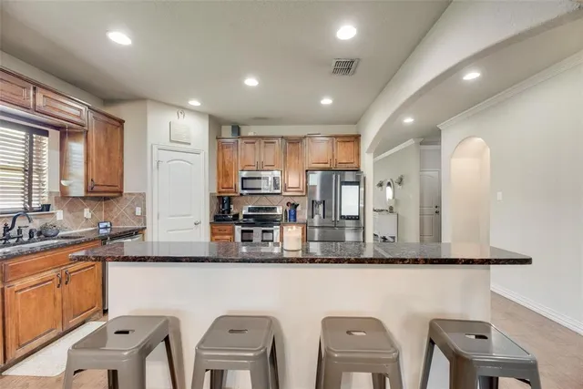 a large kitchen with lots of counter space cabinets and furniture