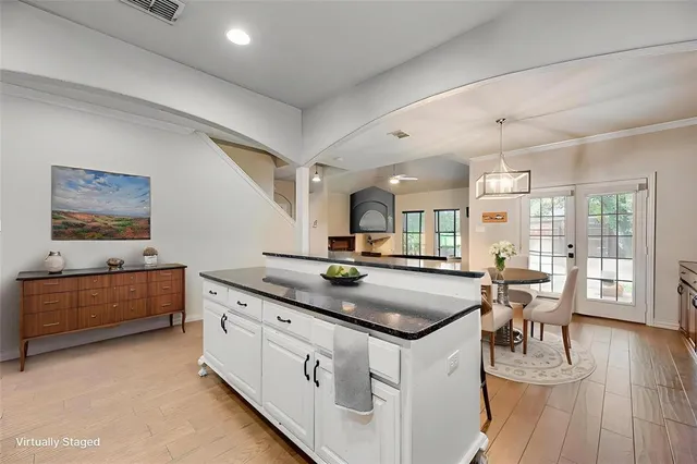 a kitchen with sink stove and wooden floor