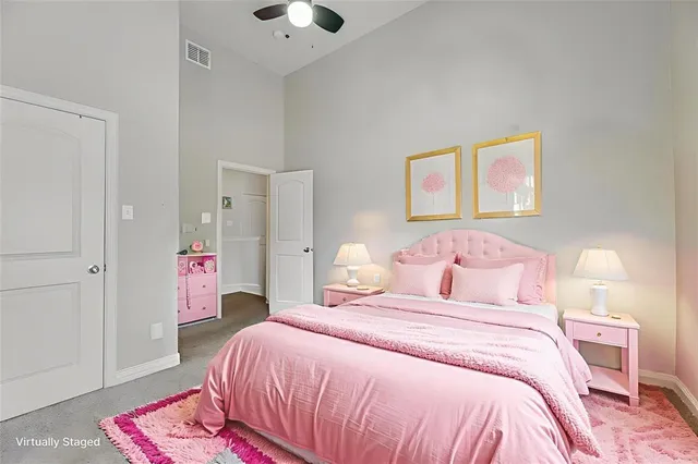 a bedroom with a bed and a painting on the wall