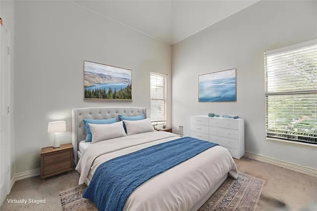 a bedroom with bed and a window