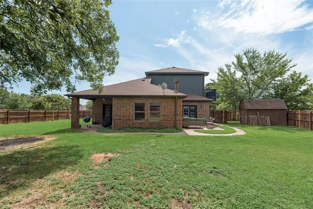 a front view of a house with a garden and trees