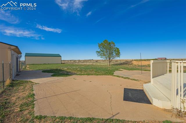19290 Loop Road Colorado Springs, CO 80928 - Photo 27 of 39 View of patio / terrace with a rural view