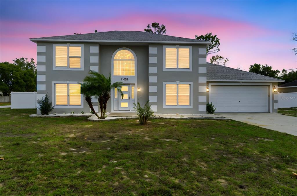 a front view of a house with a yard
