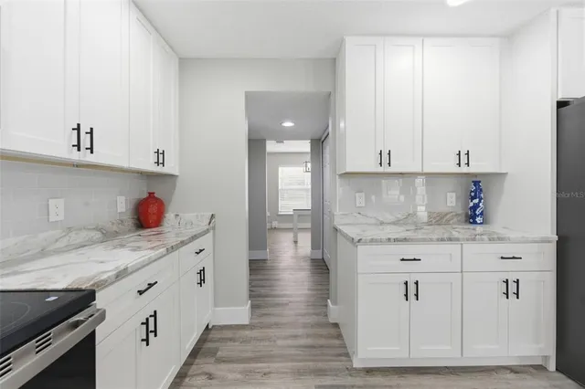 a view of an empty room and wooden floor