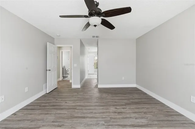 a bathroom with a granite countertop toilet sink and mirror