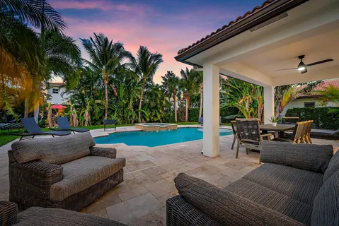 a view of a patio with couches and a fire pit