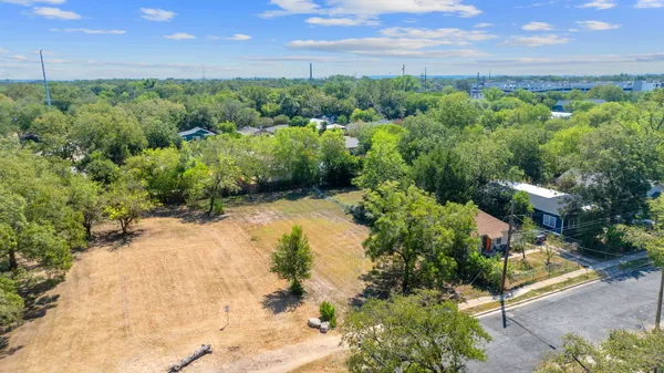 a view of a city with lush green forest