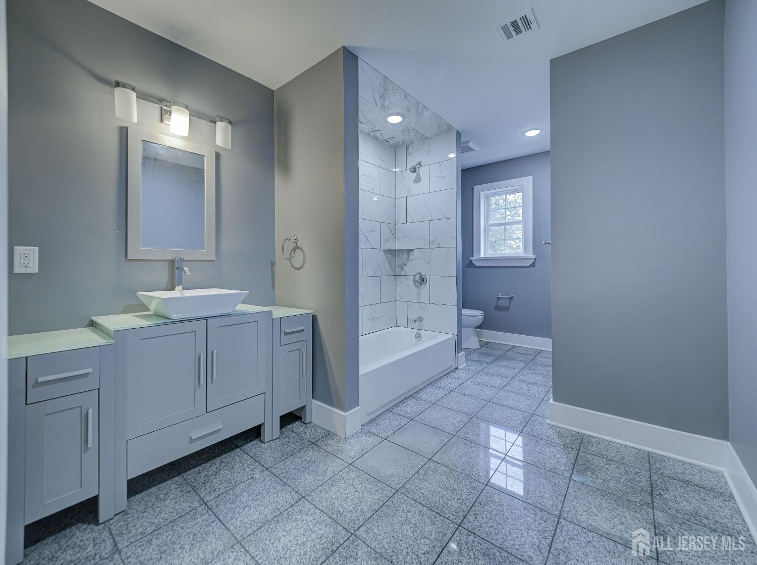 8 Travers Avenue, Unit 1 Edison, NJ 08817 - Photo 13 of 19 a bathroom with a sink a toilet and shower