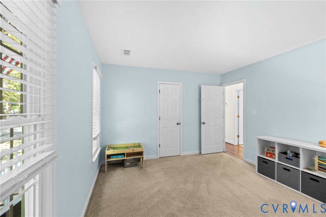1144 Timber Trace Road Powhatan, VA 23139 - Photo 16 of 40 Carpeted room with light blue walls, multiple wind